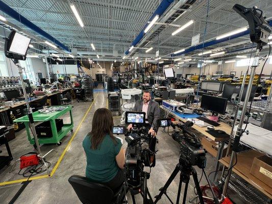 Filming an interview for training video content at Sun Nuclear's warehouse facility