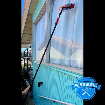 Using our Water Fed Pole method to wash high windows with pure water. Leaving the window looking spotless.