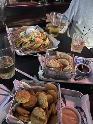 A table full of food to try! Fried pickles, potstickers and chicken nachos- everything was great!