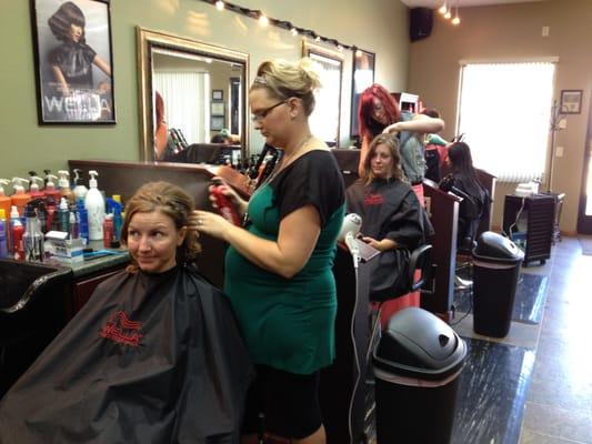 The bride and a bridesmaid getting their hairs done