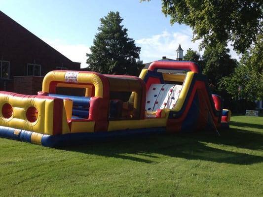 Obstacle course attached to rock climb slide