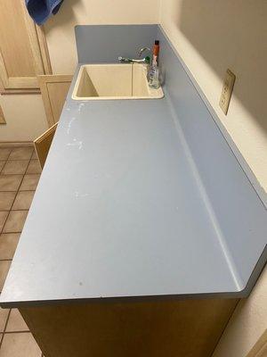 old laminated countertop with fiberglass sink