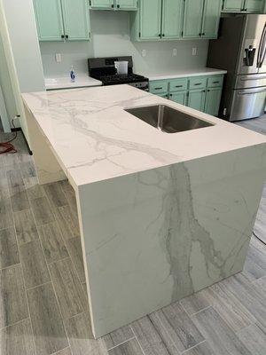 A recent kitchen remodel with Quartz countertops on perimeter counters and Porcelain Slab Island.