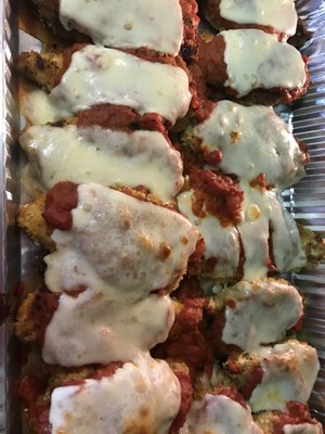 Hand Breaded Chicken Parmesan with homemade red sauce and mozzarella cheese