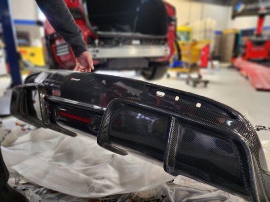 Aftermarket carbon fiber diffuser install for Tesla