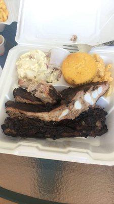 Potato salad, cornbread muffin, mac n cheese, and pork ribs