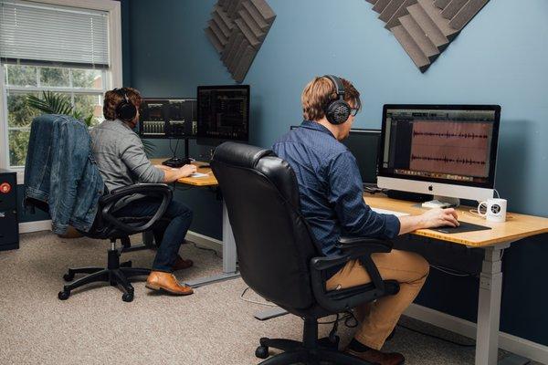 Two Professional Audio Engineers edit and mix podcasts in the studio