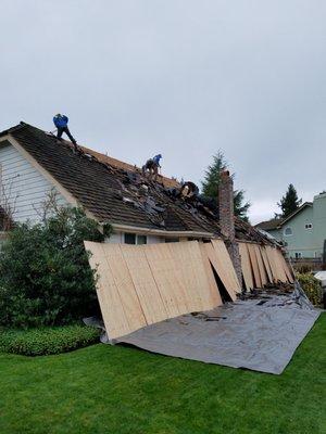 Tarps and plywood collect debris and protect siding