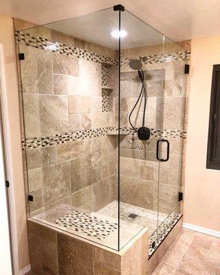 Frameless shower with oil rubbed bronze hardware and 3/8 clear glass.