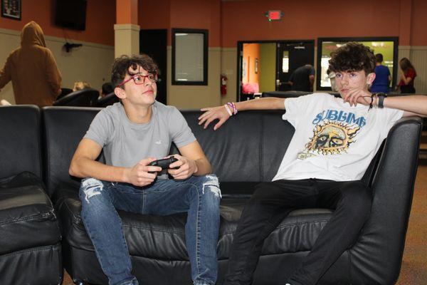 Students playing video games in the gameroom.