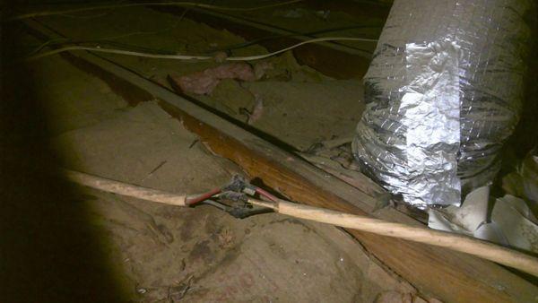 Unsafe wiring of 220 volt AC line is not protected by box or cover, can shock if stepped on or bumped into in the attic,handyman wiring