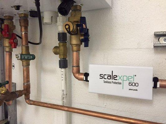 Installed Scalexpel tankless protection unit to significantly reduce scale ( mineral build-up) inside the heater.