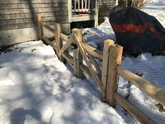 Locust post and rail. Black mesh so the dogs can't get out, this is a double gate 6 feet wide