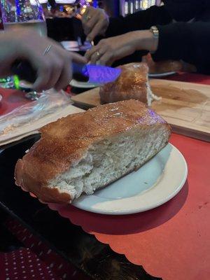 Huge loaf of bread that comes with a meal order, this is just a piece of it. Hot fresh and delicious.