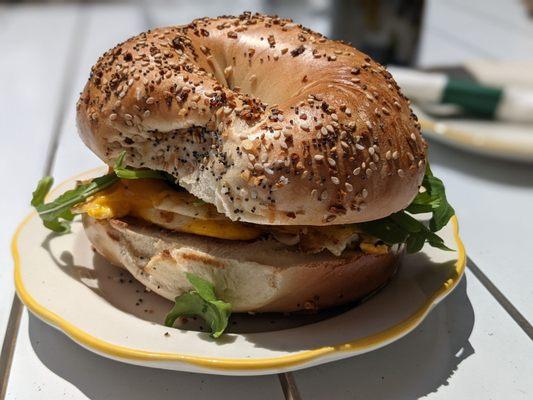 Eggs and greens on an everything bagel