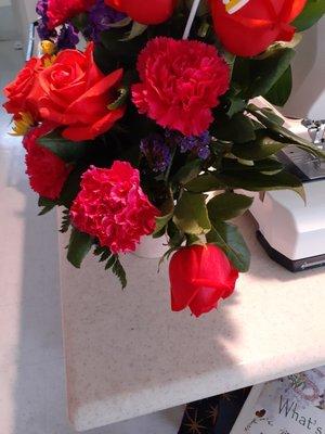 Carnations already past bloom, rose wilting, another rose ready to start dropping petals. Looks like end of day stuff