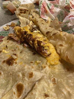 Burned eggs, burned quesadilla. No eggs in a egg burrito.