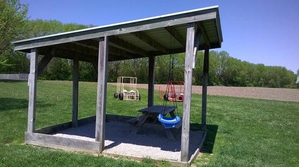 small shelter and some "vehicles" for kids to play on