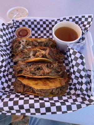 Bomb friggin birria tacos with queso, consomé