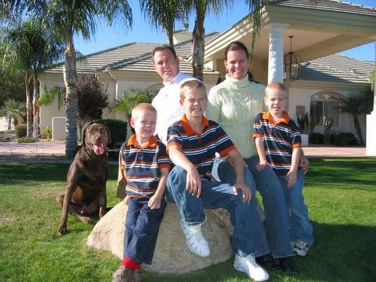 The Family in front of the House with our chocolate lab...Memphis!