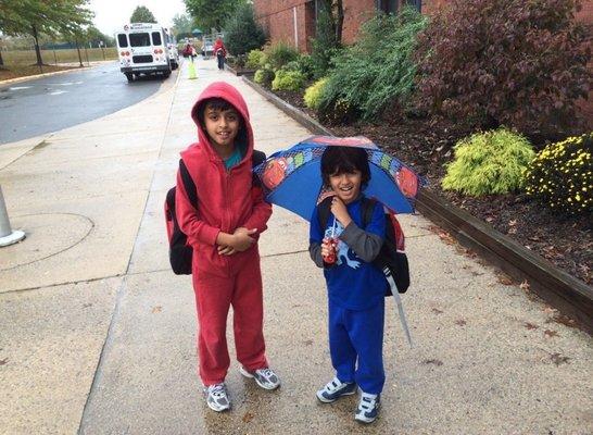 Two kids outside in the rain!