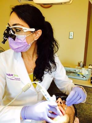 Dr. Maryam using an intra-oral camera for better patient education and involvement in treatment decisions.