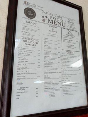 Menu hanging in wall as you come in.