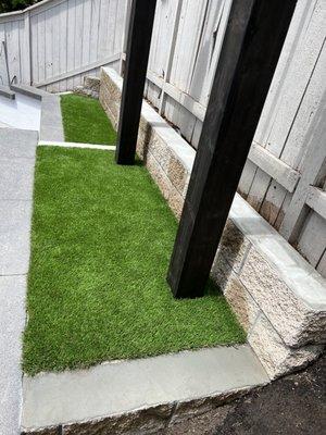 Split face CMU wall and Artificial turf.