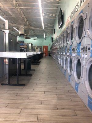 Drying machines line the wall.