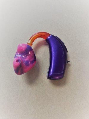 Pink and purple pediatric hearing aid. Try not to be jealous!