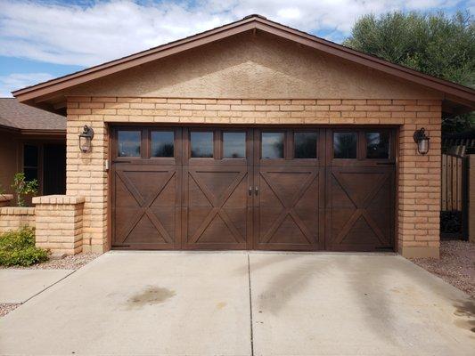 First United Door Technologies Carriage House Garage Door Hand Stained to look like Wood.