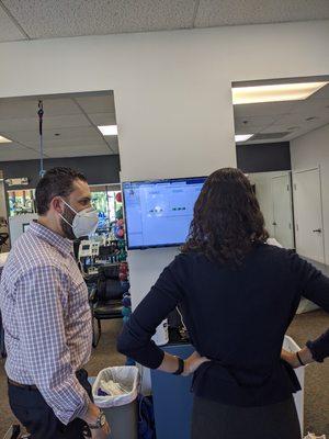 Dr. Joshua Davis, DPT working with a student on the BERTEC balance plate.