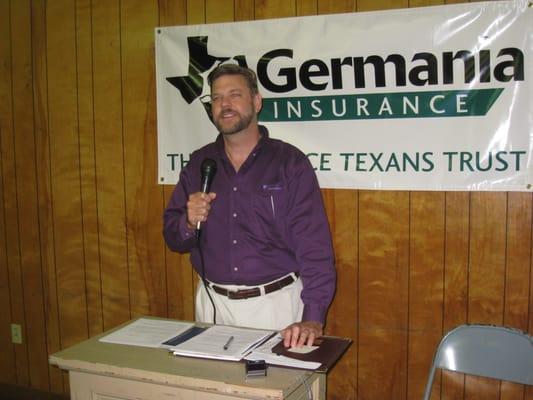 Russell leading a meeting of Germania Farm Mutual members.