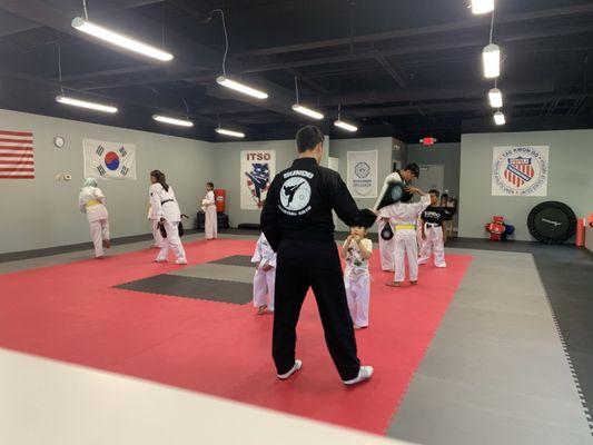 Instructor Johnathan & Instructor Brandon both 3rd Degree along with Jr. Master Jen 4th degree teaching 3 to 11 year old class