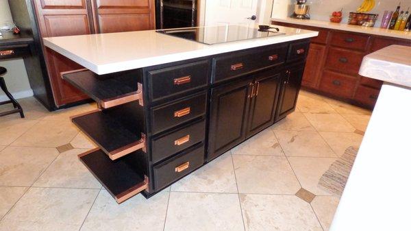 Refinished cabinets with copper handles.