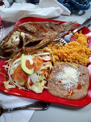 Whole fried fish with rice and beans