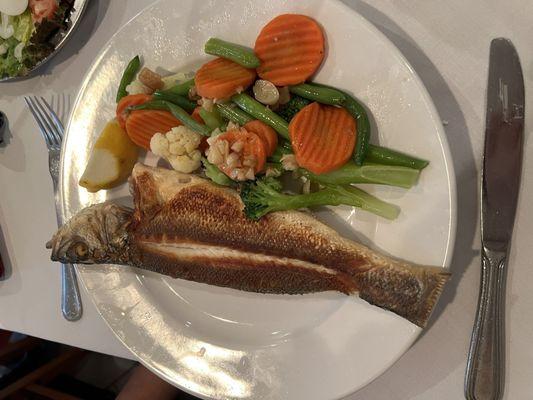 Broiled bronzino with steamed vegetables.