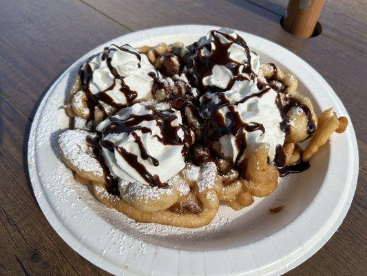 Regular funnel cake with whipped cream and chocalate syrup