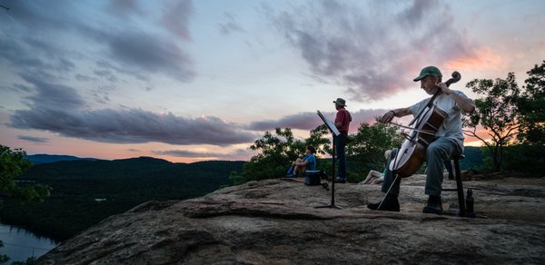 Cellist Walter Gray plays on top of Rattlesnake Mountain at Sunset.