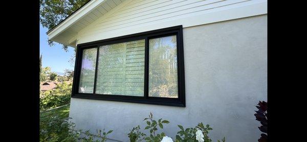 Window with precast casing amidst smooth stucco