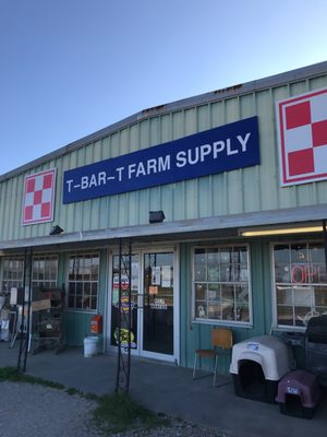 Front of store with posted hours and "Open" sign on.