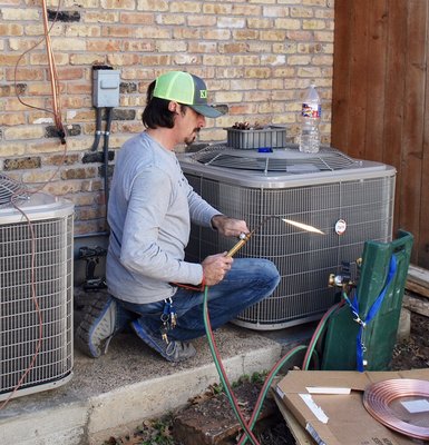 CJ Johnson installing a condenser.