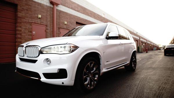 BMW X5, full color change wrap - Avery SW900 gloss white, custom prep and wrapped side steps and factory plastic