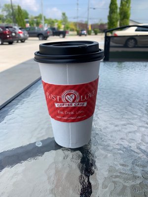 Outside seating on the sidewalk while sipping a medium oat milk Caramel Latte