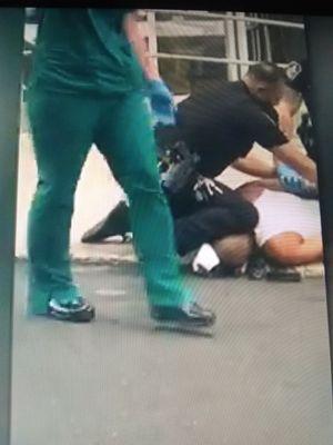 Allentown Sacred Heart nurse watching the police with a knee on a guys neck thats just needing help. Tries to block filming it WTH ??