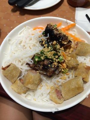 Grilled beef with egg roll on vermicelli.