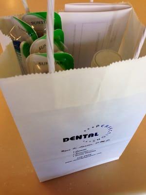 Goodie bag filled with toothbrushes and floss!