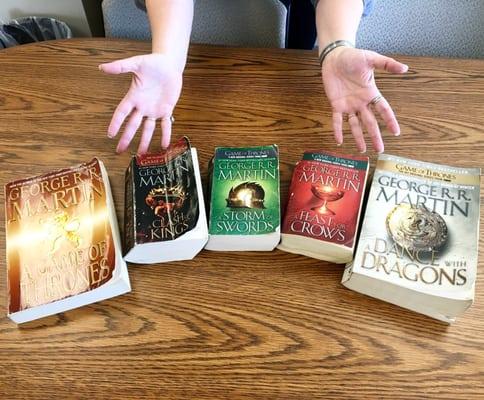 Colleague Tammy (hands in pic) clued me to Game of Thrones set only 50 cents/book in lobby rummage-sale -"Winter is Coming"