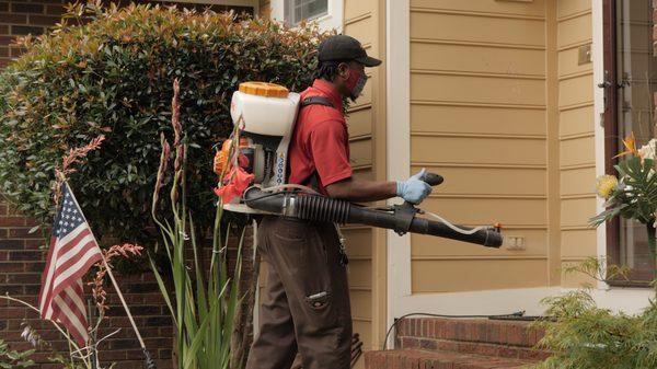 Account Manager spraying outside a residence.