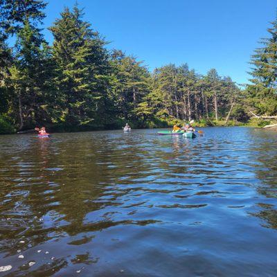 Family on rented kayaks on Beaver Creek, Oregon. Brian Booth State Park.